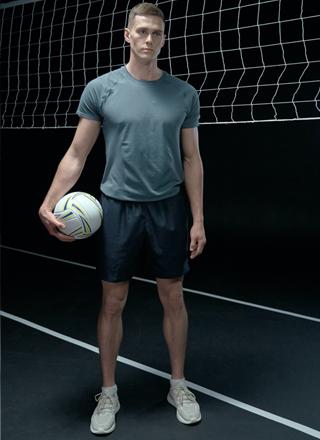 man-posing-in-volleyball-court-wear-volleyball-uniform