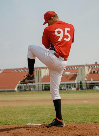 Player-posing-through-ball-wear-baseball-pant