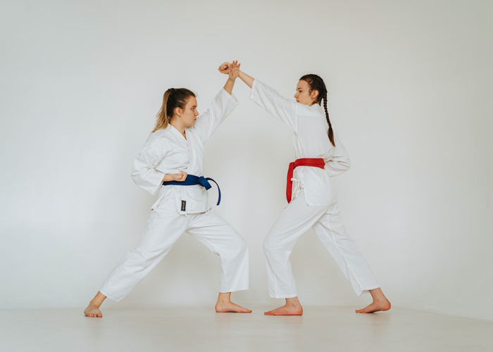 karate-woman-jumping-full-shot-wear-karate-uniform