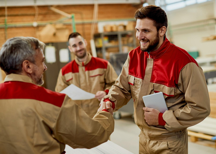 happy-carpenter-handshaking-with-is-colleague-while-greeting-workshop