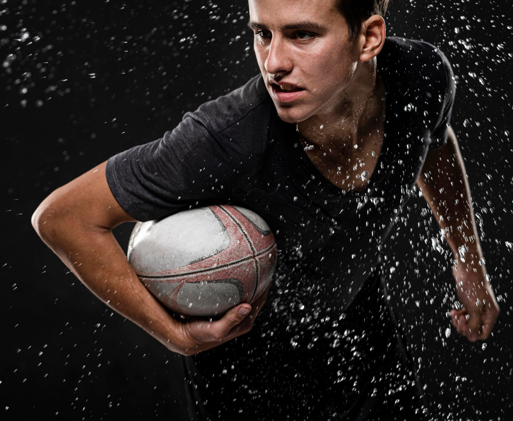 male-rugby-player-with-ball-water-splashes-(1)