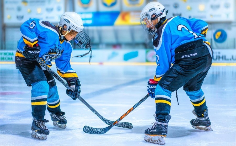 players are playing wear ice hockey uniforms